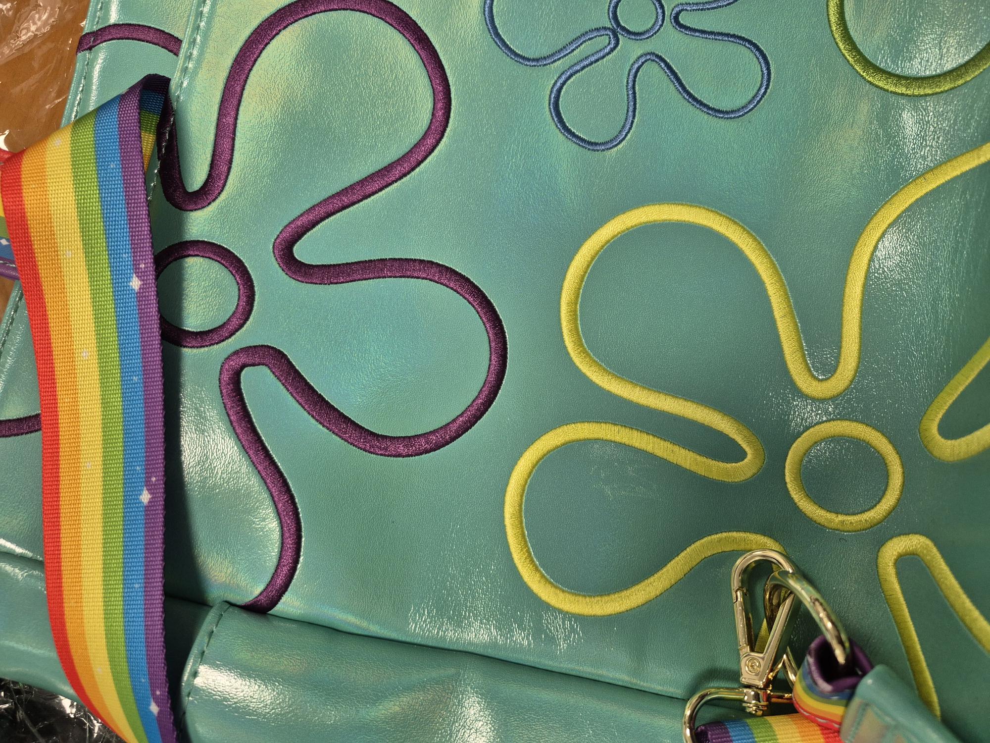 rugged bag, teal bag, purple and yellow piping, rainbow strap, patterned stitch