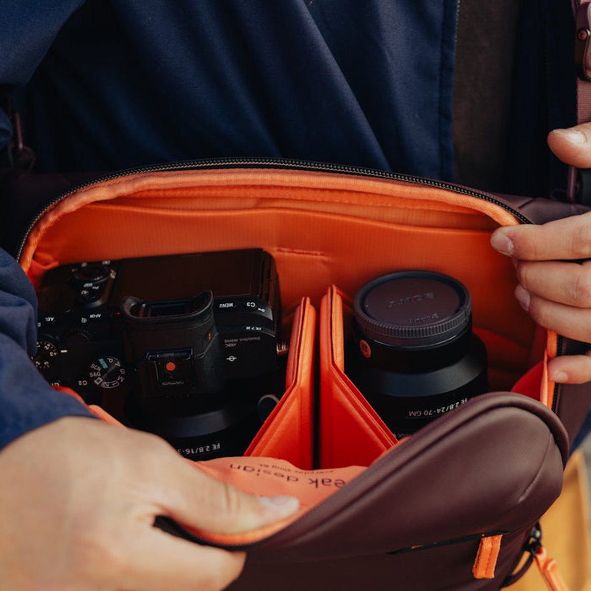 camera bag, orange interior, camera gear, lens case, zippered bag