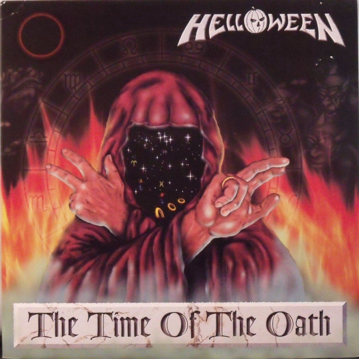 hooded figure, fire motif, astrological circle, the time of the oath, helloween